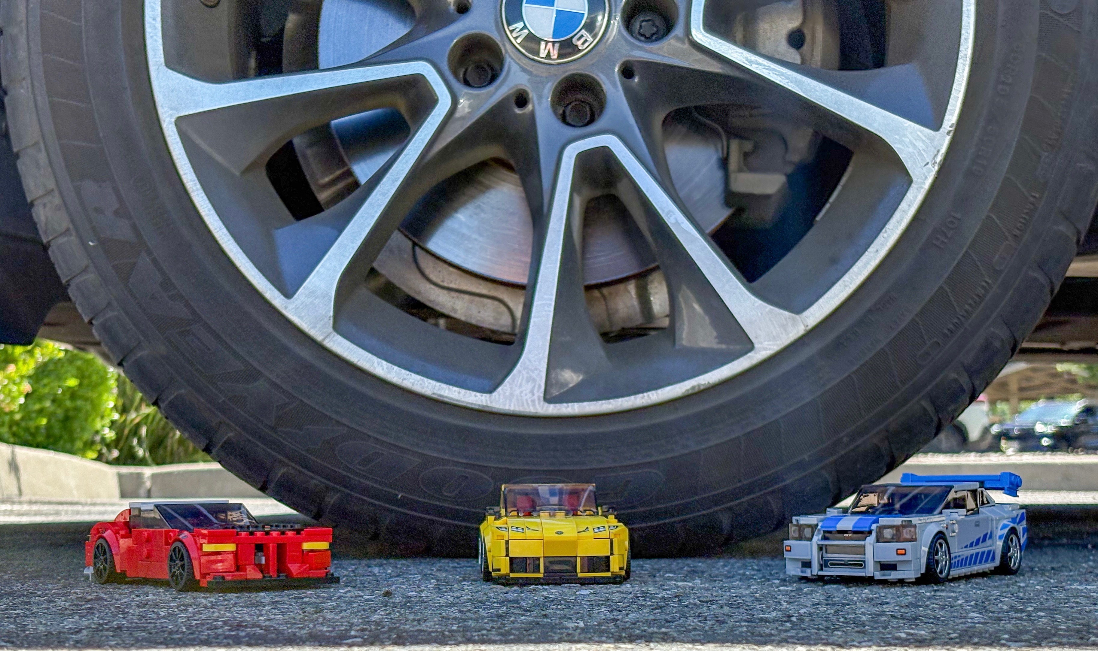 A Lego brick car fitted with custom 3D printed wheel rims